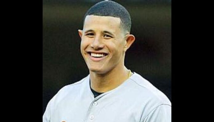 Manny Machado wearing his Baltimore jersey and smiling.