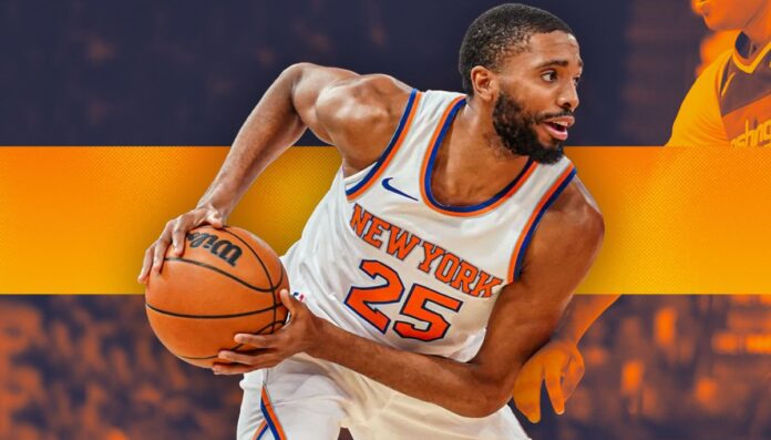 Mikal Bridges wearing his New York Knicks jersey and holding a basketball